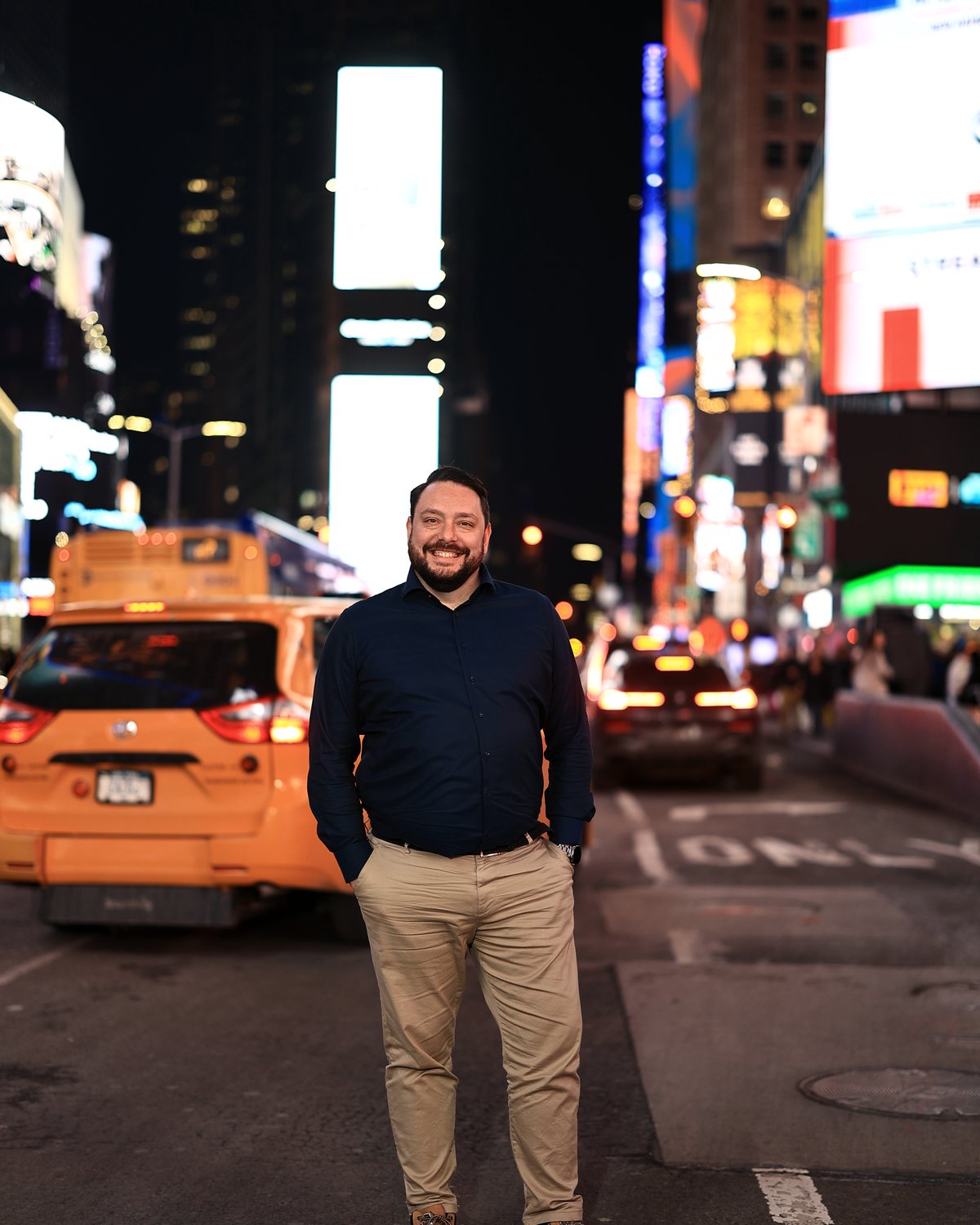Kevin Veenman smiling in Times Square, New York