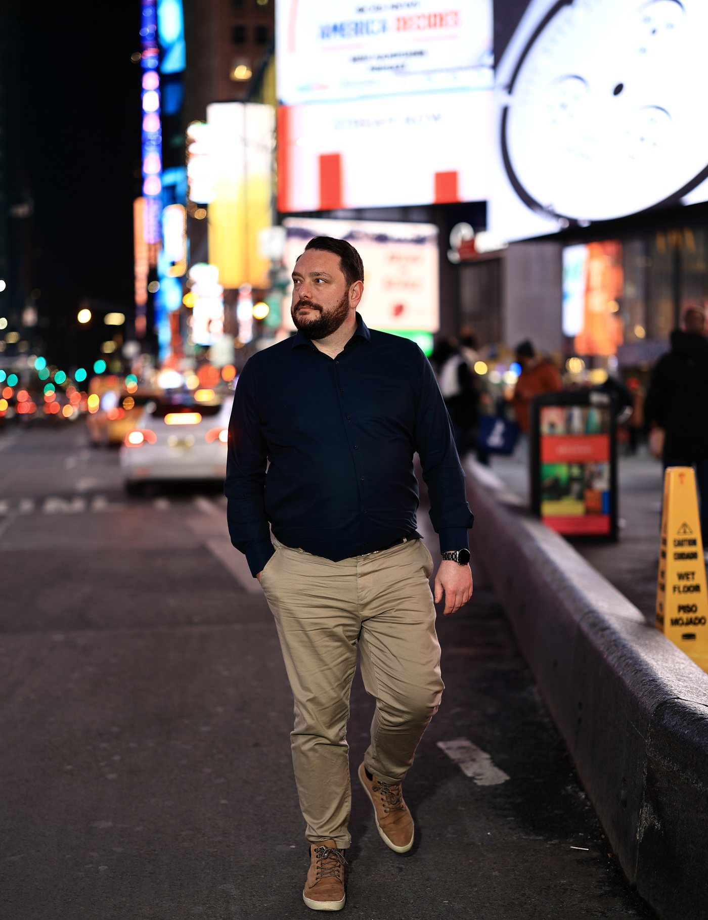 Kevin Veenman walking through Times Square, New York, at night